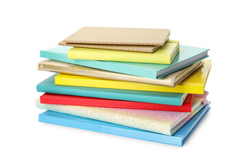 Stack of different colorful hardcover planners on white background