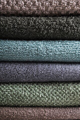 Stack of towels pastel colors. Close up, texture, vertical