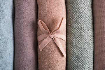 Clean folded towels pastel colors. Bath accessories, home spa. Texture, top view, flat lay