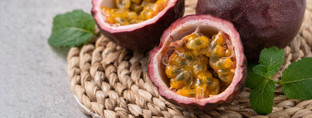 Delicious juicy passion fruit on gray table background.