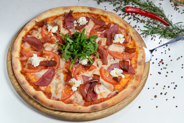 pizza with bacon on a white plate
