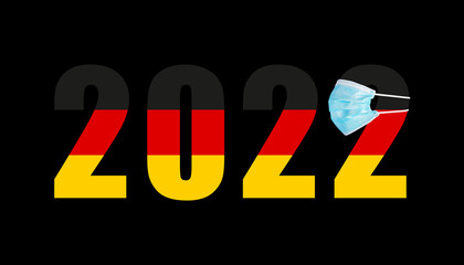 2022 with flag of Germany and medical mask for protection against covid on black background