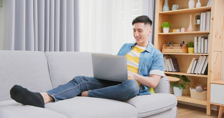 man uses laptop at home