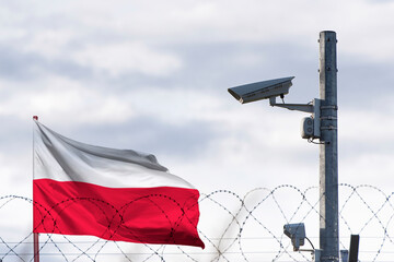Poland flag behind of barbed wire and Surveillance camera.