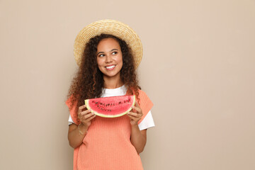 Beautiful young African American woman with slice of watermelon on beige background. Space for text