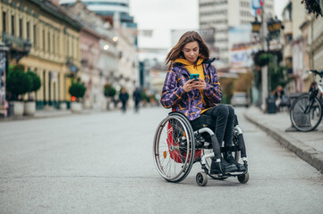 Woman with disability using a smartphone while out in the city