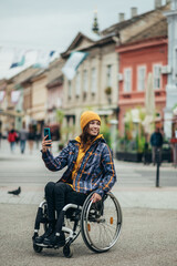 Woman with disability taking a selfie with her smartphone while out in the city