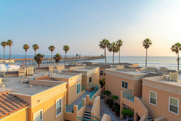 View of roof decks of complex buildings with beach waterfront at Oceanside, California