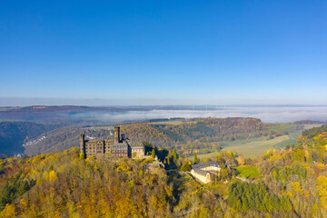 Naklejka premium Bird's eye view of the magnificent Schaumburg Castle near Balduinstein / Germany on the Lahn in autumn 