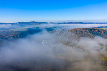 View from above of the morning mist over the Lahn valley near Balduinstein / Germany in autumn 
