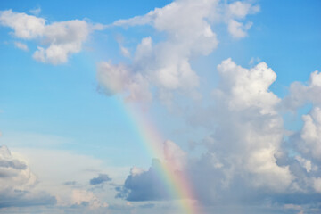 Fototapeta na wymiar Blue sky with cloud and rainbow