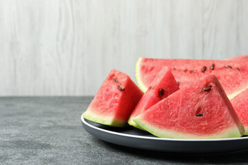 Delicious fresh watermelon slices on grey table. Space for text