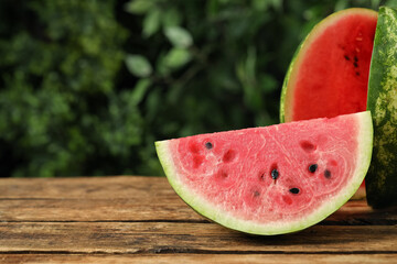 Fototapeta na wymiar Delicious fresh watermelon slices on wooden table. Space for text