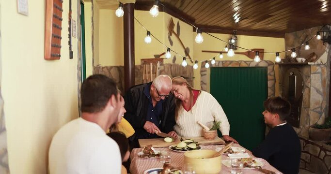 Happy latin family cooking together during dinner time at home