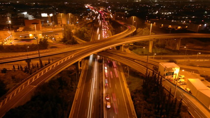 Aerial drone long exposure night photo of urban elevated road junction and interchange overpass in...