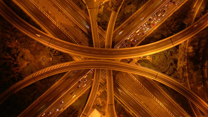 Aerial drone long exposure night photo of urban elevated road junction and interchange overpass in...