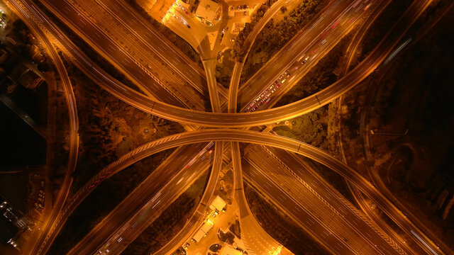 Aerial drone long exposure night photo of urban elevated road junction and interchange overpass in city with light traffic