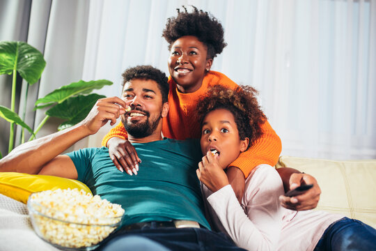 Relaxed African American Family Watching Tv Together.