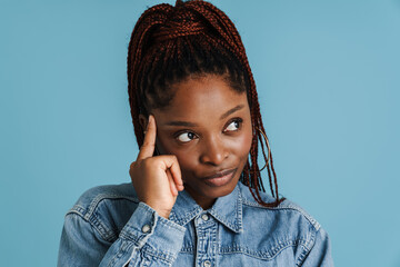 Young black woman with afro pigtails thinking and looking aside