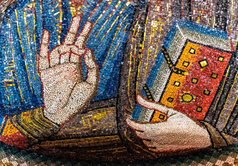 Detail of medieval religious mosaic showing symbolic gesture made by Jesus with his hand