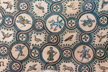 Detail of ancient mosaic showing mythical characters portraited inside circles