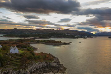 Stunning rocky beach and highlands at Elgol on the Isle of Skye under a cloudy sunset sky, Scotland