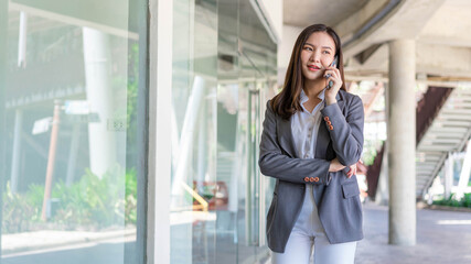 Fototapeta premium Working woman concept a working woman with smiley face speaking on the phone with her business partner