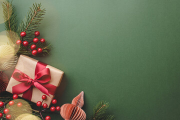 Christmas gift and decorations on green background.