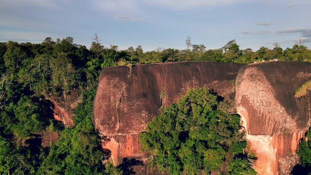 Aerial view slide shot in front of Three Whale Rocks (Hin Sam Wan)with tourists on top of the big stone like being on a whale's back, Three Whale Rocks tourist attraction at Bueng Kan amazing Thailand