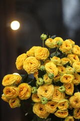bouquet of yellow vintage bush roses on the background of a window with a glowing flashlight, rose background