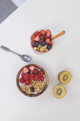 Sweet healthy yogurt with strawberry and cereal in wooden ball.