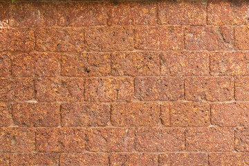 blur of red laterite brick wall Porous and fine-grained Background pattern