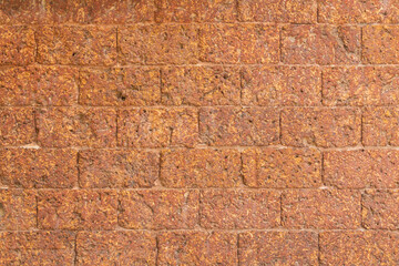 blur of red laterite brick wall Porous and fine-grained Background pattern