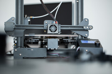 Electronic three dimensional plastic 3D printer during work in laboratory