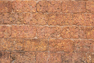 blur of red laterite brick wall Porous and fine-grained Background pattern