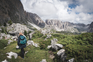 Girl hiking in dolomites. Amazing Nature Landscape near Seceda. Trentino Alto Adige, Dolomites Alps, South Tyrol, Italy.