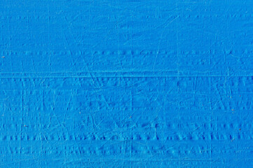 the texture of a crumpled blue tarpaulin fabric