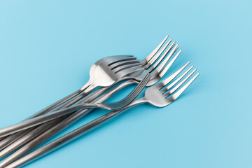 Fork. Metal cutlery on a blue background. Kitchen Utensil.