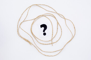 a question mark and a string of jute on a white background . FAQ frequency asked questions, Answer...