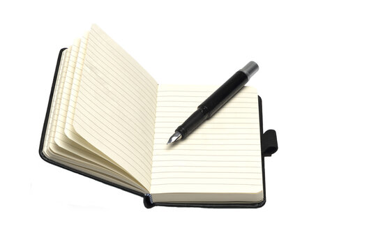 opened leather notebook with pen on white