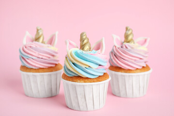 Cute sweet unicorn cupcakes on pink background