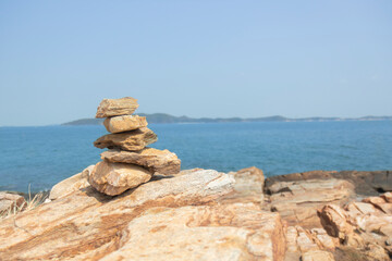 Rock on the rocks seen from above, the mountain has blue sea, island and sky as background. Eco tourism concept.