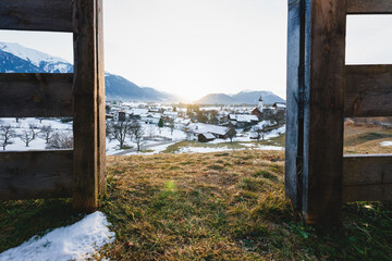 Sunset in alpine winter landscape framed by a wooden fence in the Austrian mountains, Wildermieming, Tirol, Austria