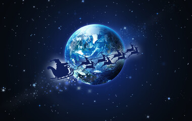 Santa Claus in a sleigh and reindeer sled flies over Earth against the background of the starry sky