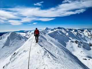Fototapeta na wymiar Climber on the top of the mountain, Buteanu Peak, Fagaras Mountains, Romania 