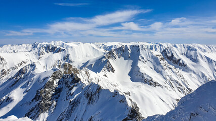 Fototapeta na wymiar snow covered mountains, viewpoint from Buteanu Peak, Fagaras Mountains, Romania 