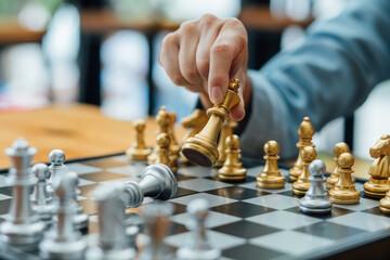 businessman hand moving gold Chess King figure and Checkmate opponent during chessboard...