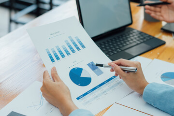 Financial businessmen analyze the graph of the company's performance to create profits and growth,...