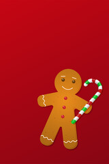 Christmas gingerbread man with a candy cane on a red background.