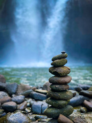 Balance stone on waterfall Bali Indonesia